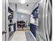 Efficient kitchen showcasing stainless steel appliances, sleek navy blue cabinets, and an adjacent dining area at 201 Surrey Ln., Myrtle Beach, SC 29579