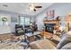 Bright living room with a brick fireplace, large windows, and plush seating, perfect for relaxation at 201 Surrey Ln., Myrtle Beach, SC 29579