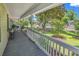 Relaxing front porch offering a picturesque view of the landscaped front yard and neighborhood at 201 Surrey Ln., Myrtle Beach, SC 29579