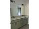 Bathroom featuring double vanity with marble countertop, grey cabinets, and large mirror at 2075 Lees Landing Circle, Conway, SC 29526