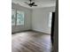 Spacious bedroom with wood-look floors, white walls, a ceiling fan, and natural light from multiple windows at 2075 Lees Landing Circle, Conway, SC 29526