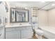 A well lit bathroom featuring a single sink vanity and shower and bath combination at 2201 S Ocean Blvd. # 103, Myrtle Beach, SC 29577