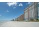Picturesque beach view showing several high-rise condo buildings in the background on a sunny day at 2201 S Ocean Blvd. # 103, Myrtle Beach, SC 29577
