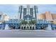 Striking blue and white multistory resort building featuring attractive design details and lush tropical landscaping at 2201 S Ocean Blvd. # 103, Myrtle Beach, SC 29577