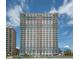 Oceanfront high-rise condo building with multiple balconies against a bright, partly cloudy sky at 2201 S Ocean Blvd. # 103, Myrtle Beach, SC 29577