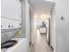 Hallway view of a washer and dryer unit leading to the kitchen and living area at 2201 S Ocean Blvd. # 103, Myrtle Beach, SC 29577