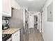 Hallway with stainless steel refrigerator and view of bedroom at 2201 S Ocean Blvd. # 103, Myrtle Beach, SC 29577