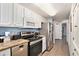Modern kitchen featuring white cabinets, stainless steel appliances, and granite countertops at 2201 S Ocean Blvd. # 103, Myrtle Beach, SC 29577