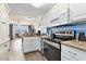 Open-concept kitchen with granite countertops, stainless steel appliances, and views of the living area at 2201 S Ocean Blvd. # 103, Myrtle Beach, SC 29577