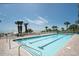 Outdoor pool with lane lines and a spacious deck area by the beach under a clear blue sky at 2201 S Ocean Blvd. # 103, Myrtle Beach, SC 29577