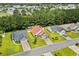 Birds eye view of a home with a red roof and driveway, nestled in a lush, green neighborhood at 221 Tibton Circle, Myrtle Beach, SC 29588
