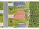 Overhead view of a house with a red roof and a fully fenced backyard in a residential neighborhood at 221 Tibton Circle, Myrtle Beach, SC 29588