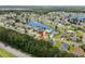 Picturesque aerial shot reveals the home's proximity to a tranquil lake within a lush green community at 221 Tibton Circle, Myrtle Beach, SC 29588