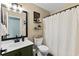 Bathroom showcasing vanity, toilet, and shower with curtains in neutral tones at 221 Tibton Circle, Myrtle Beach, SC 29588