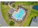 Aerial view of a sparkling community pool with lounge chairs, umbrellas, and well-maintained landscaping at 221 Tibton Circle, Myrtle Beach, SC 29588