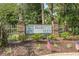Community sign for Palmetto Glen features brick pillars, landscaping, and American flags at 221 Tibton Circle, Myrtle Beach, SC 29588