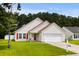 Charming single-Gathering home with attached garage, manicured lawn, and colorful red door and shutters at 221 Tibton Circle, Myrtle Beach, SC 29588