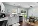 Bright kitchen features white cabinets, stainless appliances, and sliding glass doors to the backyard at 221 Tibton Circle, Myrtle Beach, SC 29588