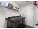 Well-organized laundry room with washer, dryer, and shelving for storage at 221 Tibton Circle, Myrtle Beach, SC 29588
