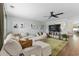 Open living area with large sectional, neutral tones, green rug, and a view into the dining area at 221 Tibton Circle, Myrtle Beach, SC 29588