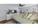 Large main bedroom featuring a dresser with TV, plant, and a view of the bed with green linens at 221 Tibton Circle, Myrtle Beach, SC 29588