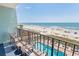 Relaxing balcony view of a pool and beach offering ocean vistas, perfect for enjoying the outdoors and sea breeze at 2311 S Ocean Blvd. # 437, Myrtle Beach, SC 29577