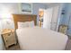 Comfortable bedroom with queen bed, nautical art, and access to the compact kitchen at 2311 S Ocean Blvd. # 437, Myrtle Beach, SC 29577