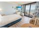 Inviting bedroom offering balcony access with ocean views, complemented by nautical decor and a cozy seating area at 2311 S Ocean Blvd. # 437, Myrtle Beach, SC 29577