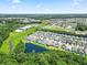 Aerial view of a community with a serene pond featuring a fountain and manicured lawns at 236 Palm Cove Circle, Myrtle Beach, SC 29588