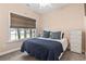 Cozy bedroom with a blue comforter, a window view, and a white dresser at 236 Palm Cove Circle, Myrtle Beach, SC 29588