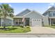 Charming single-story home with a well-manicured lawn, an attached garage, and inviting curb appeal at 236 Palm Cove Circle, Myrtle Beach, SC 29588