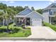 Charming single-story home with a well-manicured lawn, an attached garage, and inviting curb appeal at 236 Palm Cove Circle, Myrtle Beach, SC 29588