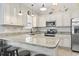 Bright kitchen with an island featuring granite countertops and a breakfast bar at 236 Palm Cove Circle, Myrtle Beach, SC 29588