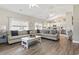 Bright and spacious living room featuring hardwood floors and an open layout flowing into the kitchen at 236 Palm Cove Circle, Myrtle Beach, SC 29588