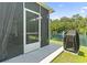 Relaxing screened porch with a view of a pond, barbecue grill, and outdoor seating area at 236 Palm Cove Circle, Myrtle Beach, SC 29588
