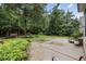 Well-maintained backyard featuring a concrete patio and lush green lawn with a porch swing at 28 Grey Moss Rd., Murrells Inlet, SC 29576