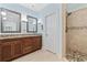 Bathroom featuring a double vanity with granite countertops and a tiled shower at 28 Grey Moss Rd., Murrells Inlet, SC 29576