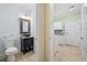 Bathroom and laundry area with a unique vanity sink, toilet, washer, dryer, and a decorative mirror at 28 Grey Moss Rd., Murrells Inlet, SC 29576
