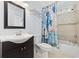 Bright bathroom with a stylish vanity, framed mirror, and a shower/tub combo with unique curtain at 28 Grey Moss Rd., Murrells Inlet, SC 29576