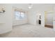 Bedroom featuring neutral carpet, a window, and ensuite bath at 28 Grey Moss Rd., Murrells Inlet, SC 29576