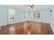 Bright bedroom with hardwood floors, large windows, and fresh light blue paint at 28 Grey Moss Rd., Murrells Inlet, SC 29576