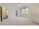 Bedroom featuring neutral carpet, a window, and ensuite bath at 28 Grey Moss Rd., Murrells Inlet, SC 29576