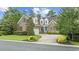 Charming brick home with manicured lawn, mature trees, and welcoming blue front door at 28 Grey Moss Rd., Murrells Inlet, SC 29576