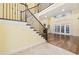 Elegant foyer features a grand staircase with decorative wrought iron railing and hardwood floors at 28 Grey Moss Rd., Murrells Inlet, SC 29576