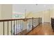 Hallway featuring decorative iron railing and hardwood floors at 28 Grey Moss Rd., Murrells Inlet, SC 29576