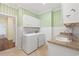 Cozy laundry room featuring a modern washer and dryer, built-in cabinets, and ample counter space at 28 Grey Moss Rd., Murrells Inlet, SC 29576
