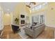 Open living room with hardwood floors, a cozy fireplace, and lots of natural light at 28 Grey Moss Rd., Murrells Inlet, SC 29576