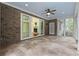 Tiled sunroom with view into the house, backyard and adjacent porch at 28 Grey Moss Rd., Murrells Inlet, SC 29576