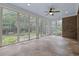 Well-lit sunroom featuring tiled floors and expansive windows overlooking lush greenery at 28 Grey Moss Rd., Murrells Inlet, SC 29576