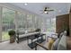 Comfortable sunroom with large windows, neutral furniture, and brick accent wall at 28 Grey Moss Rd., Murrells Inlet, SC 29576
